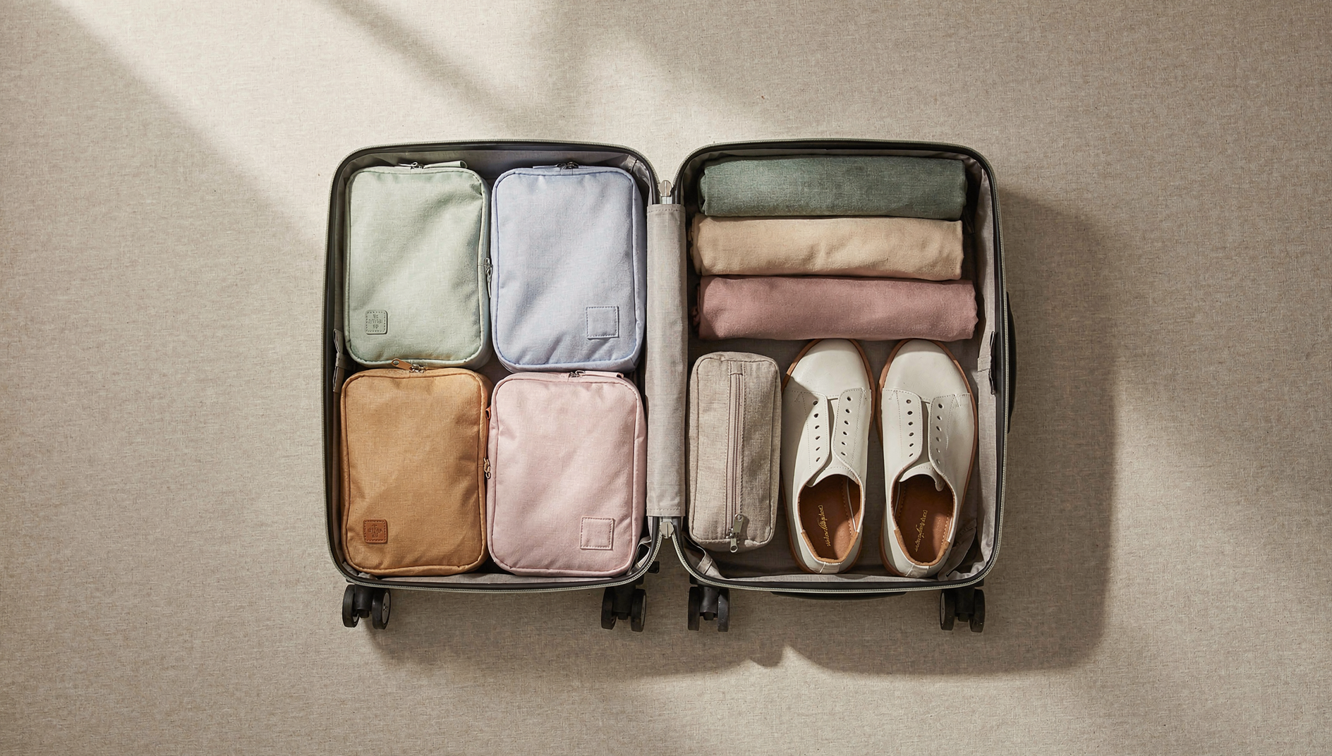 Open suitcase neatly packed with packing cubes and travel accessories