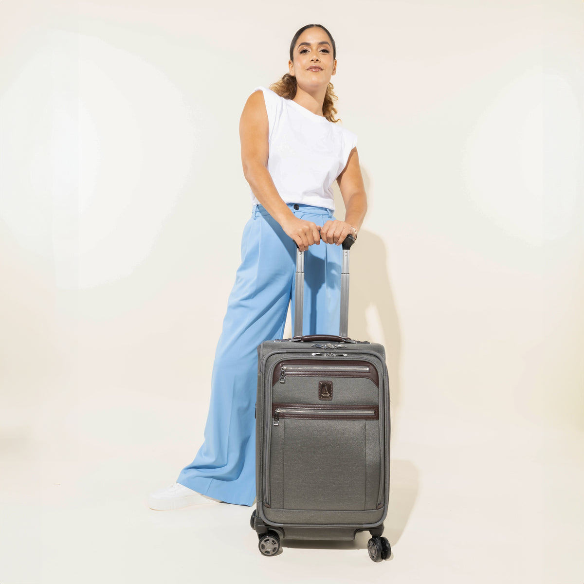 Travelpro Platinum Elite 21” Expandable Carry-On Spinner in Vintage Grey — lifestyle