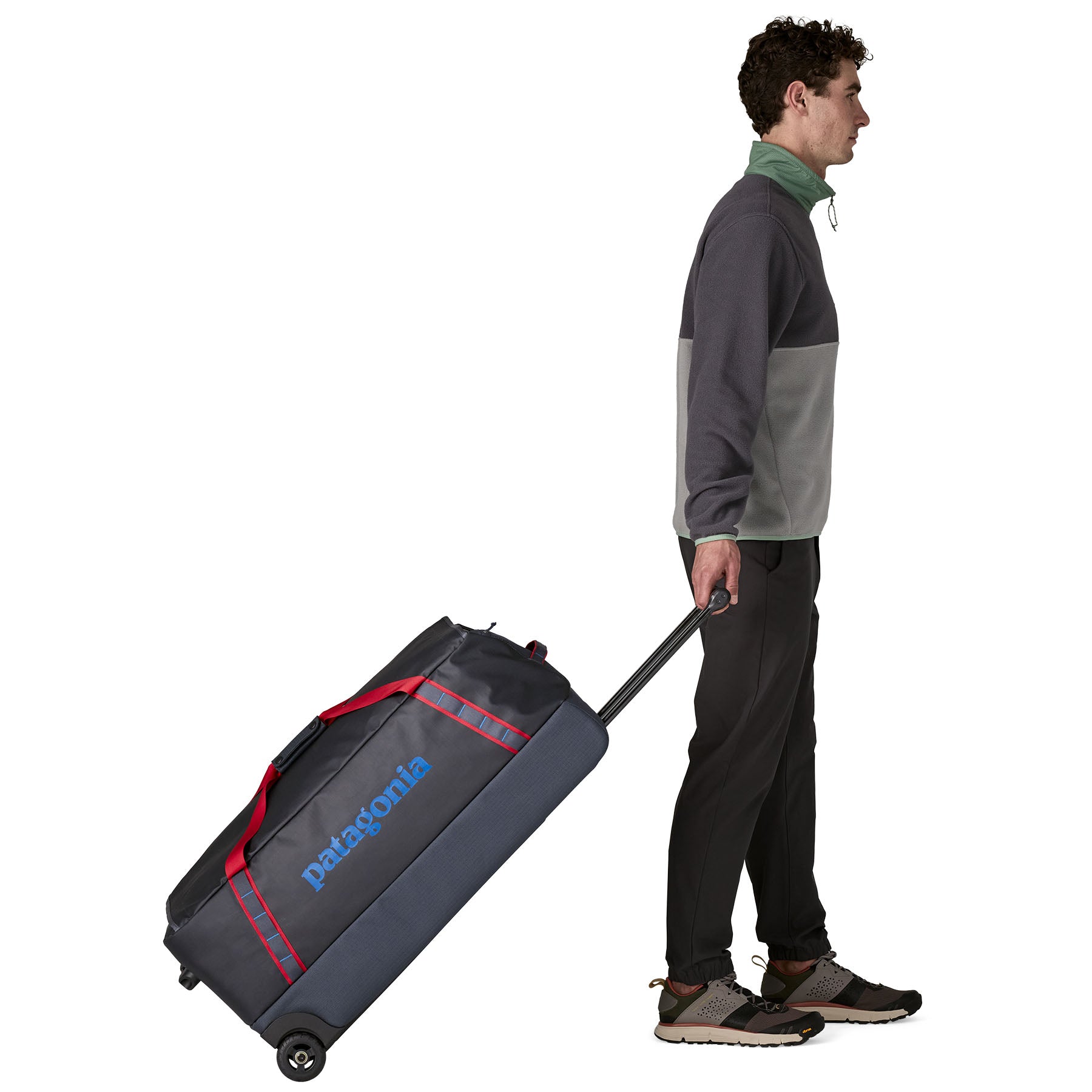 Patagonia Black Hole Wheeled Duffel 100L in Smolder Blue/Amanita Red — lifestyle