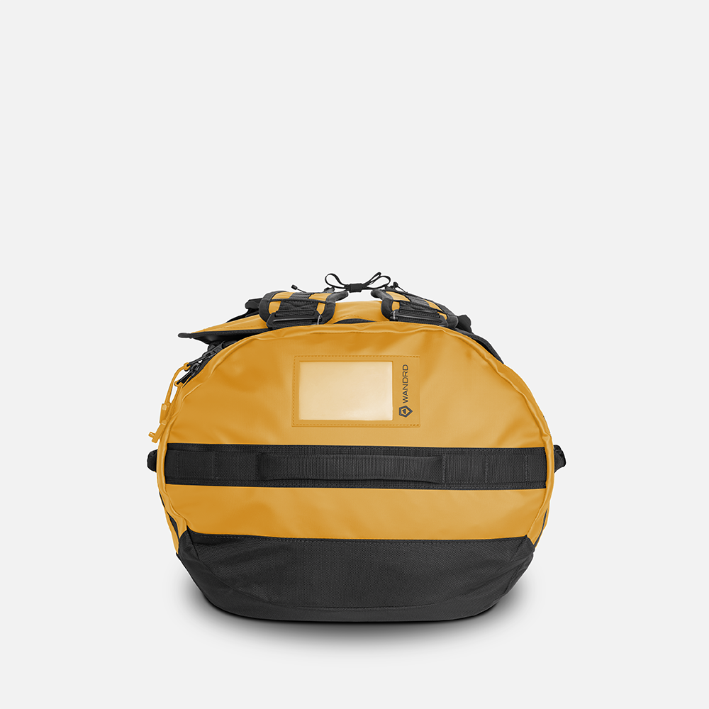 WANDRD CARRYALL Duffel 60L in Dallol Yellow — angle view 3