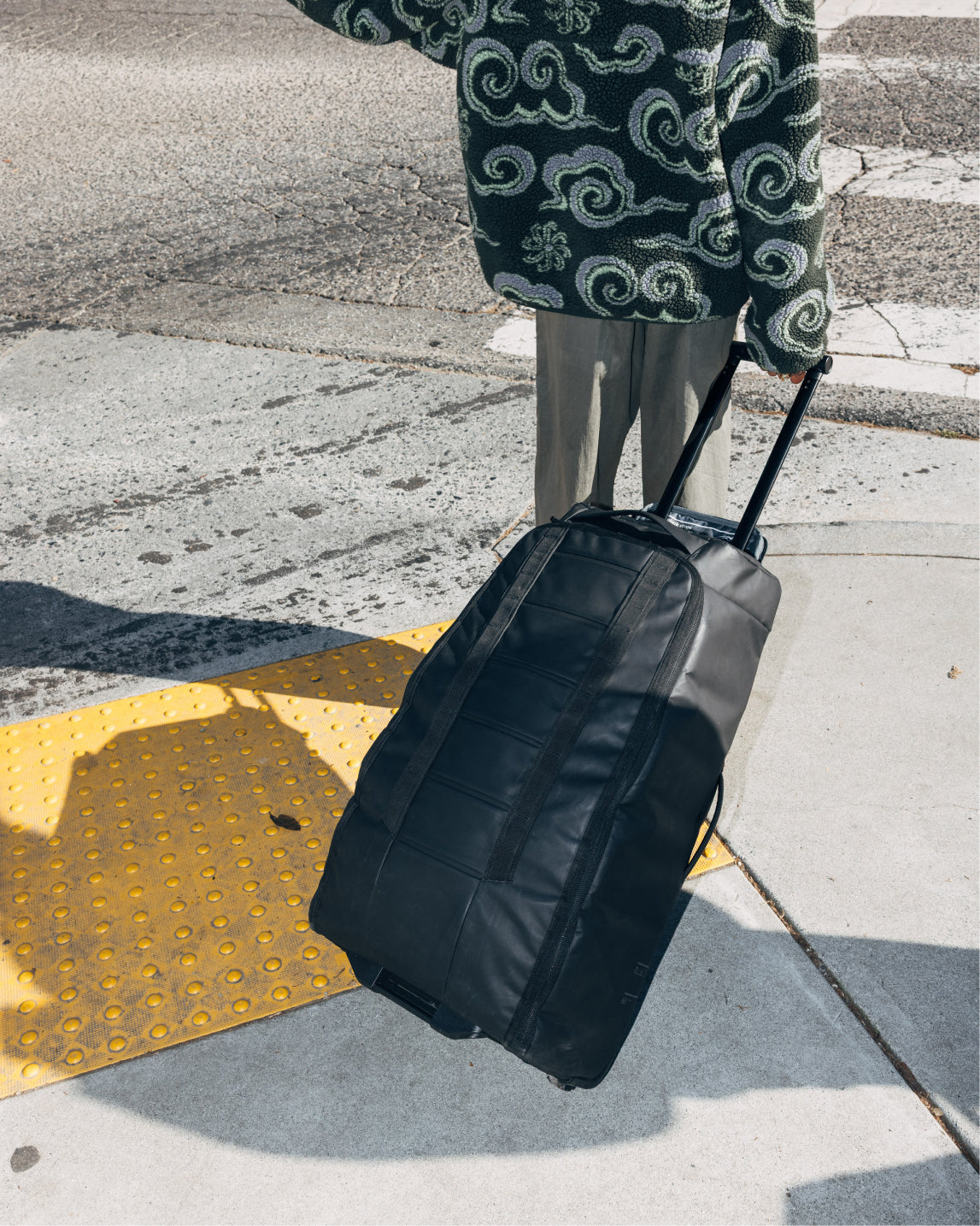 Db Journey Hugger Roller Bag Check-in 60L in Black Out — lifestyle # color_Black Out