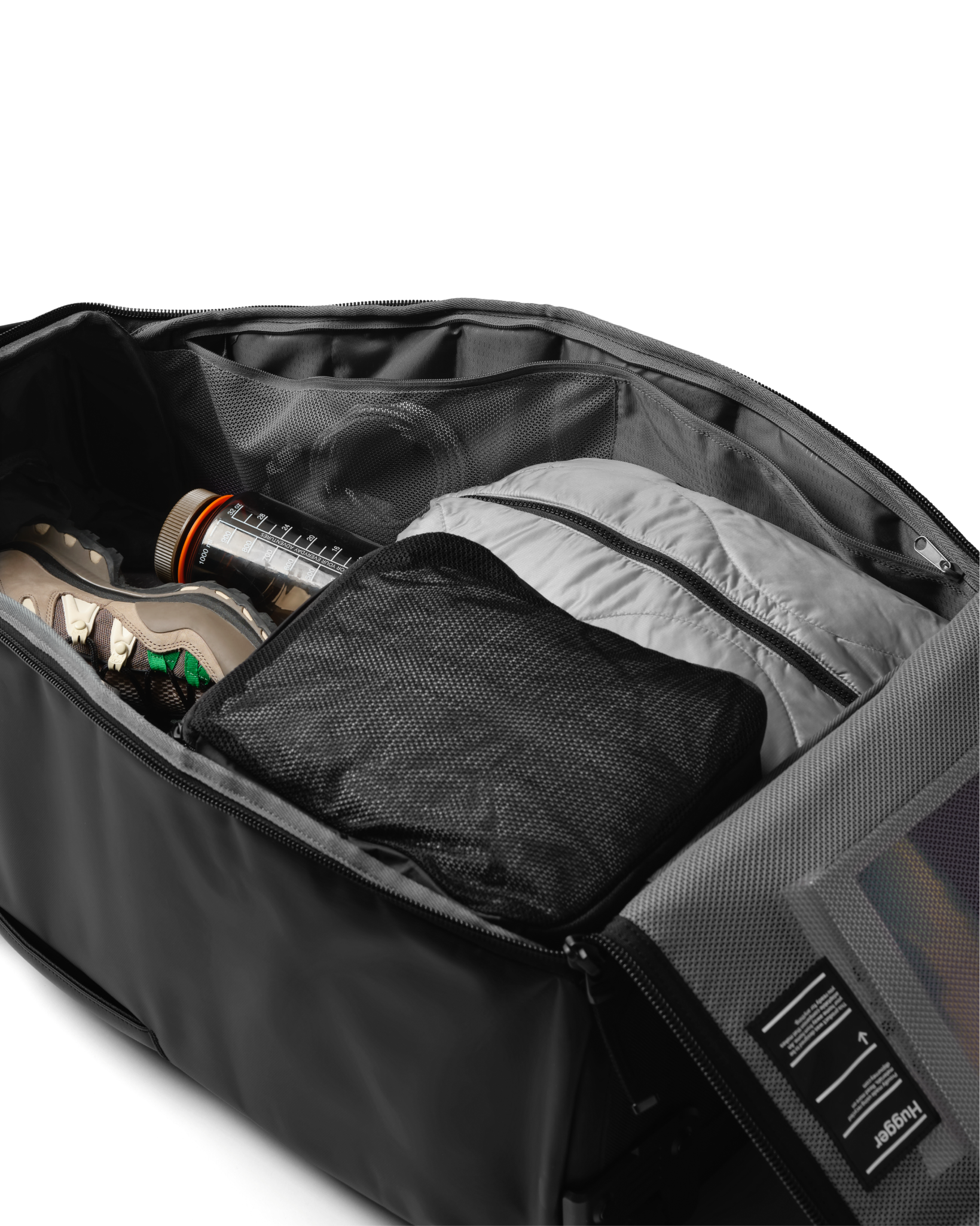 Db Journey Hugger Roller Bag Check-in 60L in Black Out — packed view # color_Black Out