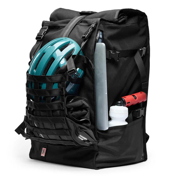 Chrome Industries Barrage Pro Pack 80L backpack – black, packed with a helmet and water bottle in the cargo net
