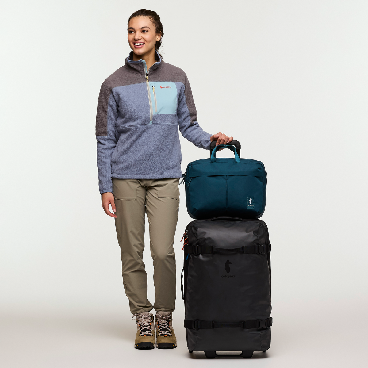 Cotopaxi Allpa 65L Roller Bag in Black — angle view 4