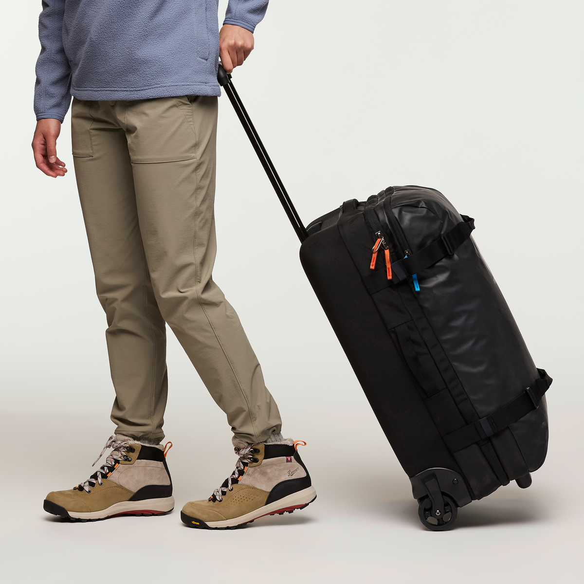 Cotopaxi Allpa 65L Roller Bag in Black — angle view 5
