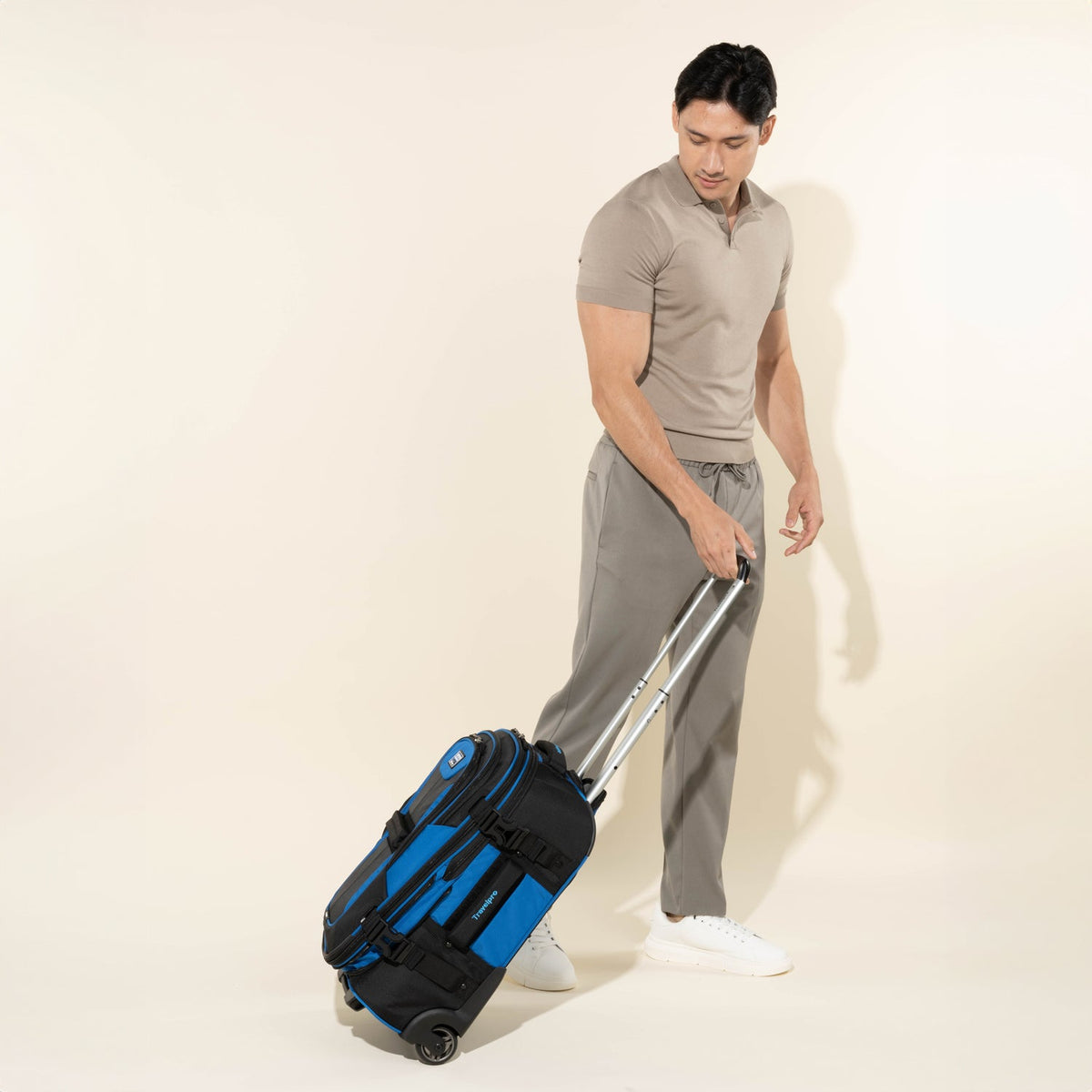 Travelpro Bold By Travelpro 22" Carry-On Expandable Rollaboard in Blue — lifestyle