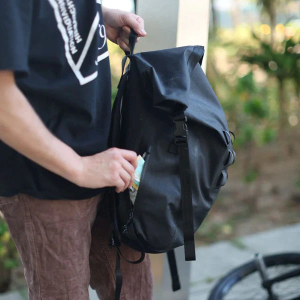 Chrome Industries Urban Ex Rolltop 30L backpack – person wearing the backpack outdoors