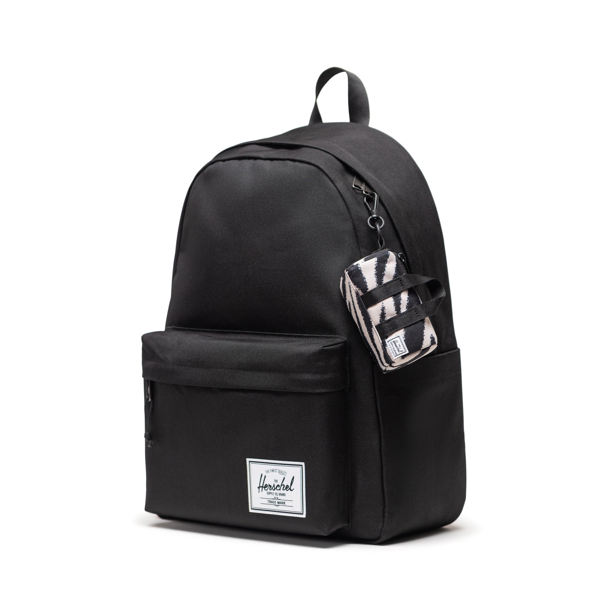 Herschel Novel Duffle Bag Charm in Zebra — shown attached to a Herschel Classic backpack