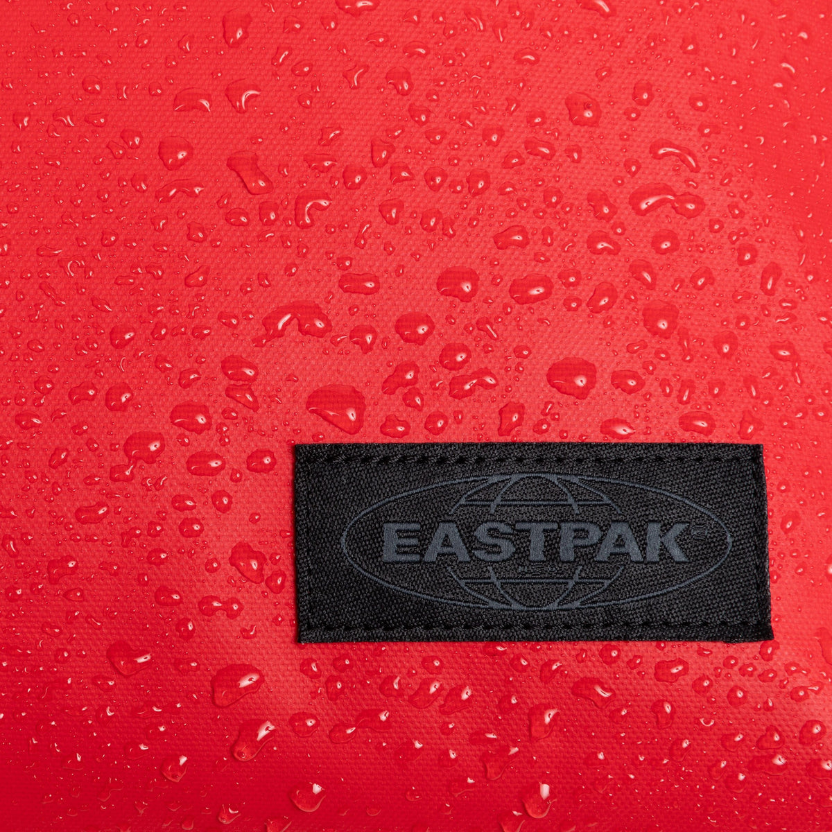 Eastpak Travelpack Backpack Tarp Edition 42L in Tarp Red — angle view 3