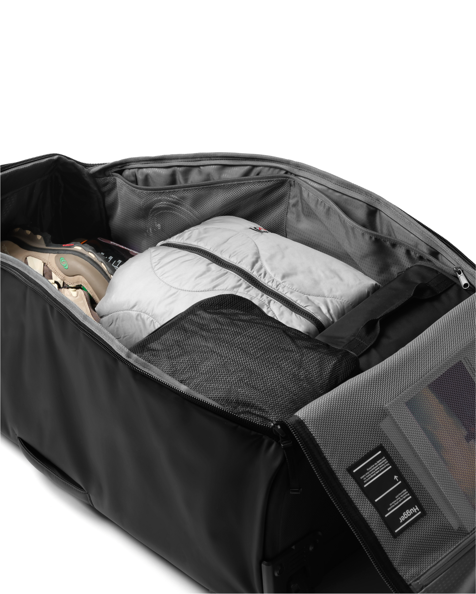 Db Journey Hugger Roller Bag Check-in 90L in Black Out — packed view # color_Black Out