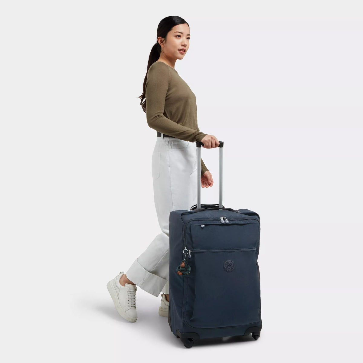 Kipling Darcey Medium Rolling Luggage in True Blue Tonal — lifestyle # color_True Blue Tonal