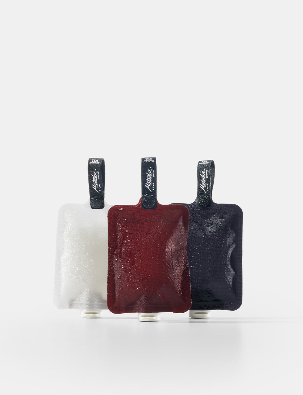 Matador FlatPak Toiletry Bottles 3-Pack in Charcoal / Garnet / Arctic White — front view