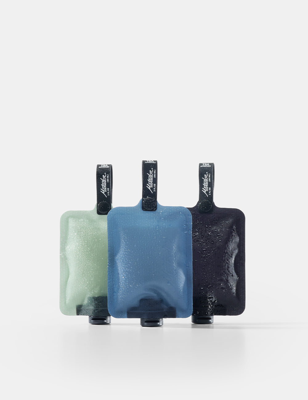 Matador FlatPak Toiletry Bottles 3-Pack in Charcoal / Slate Blue / Sage — front view