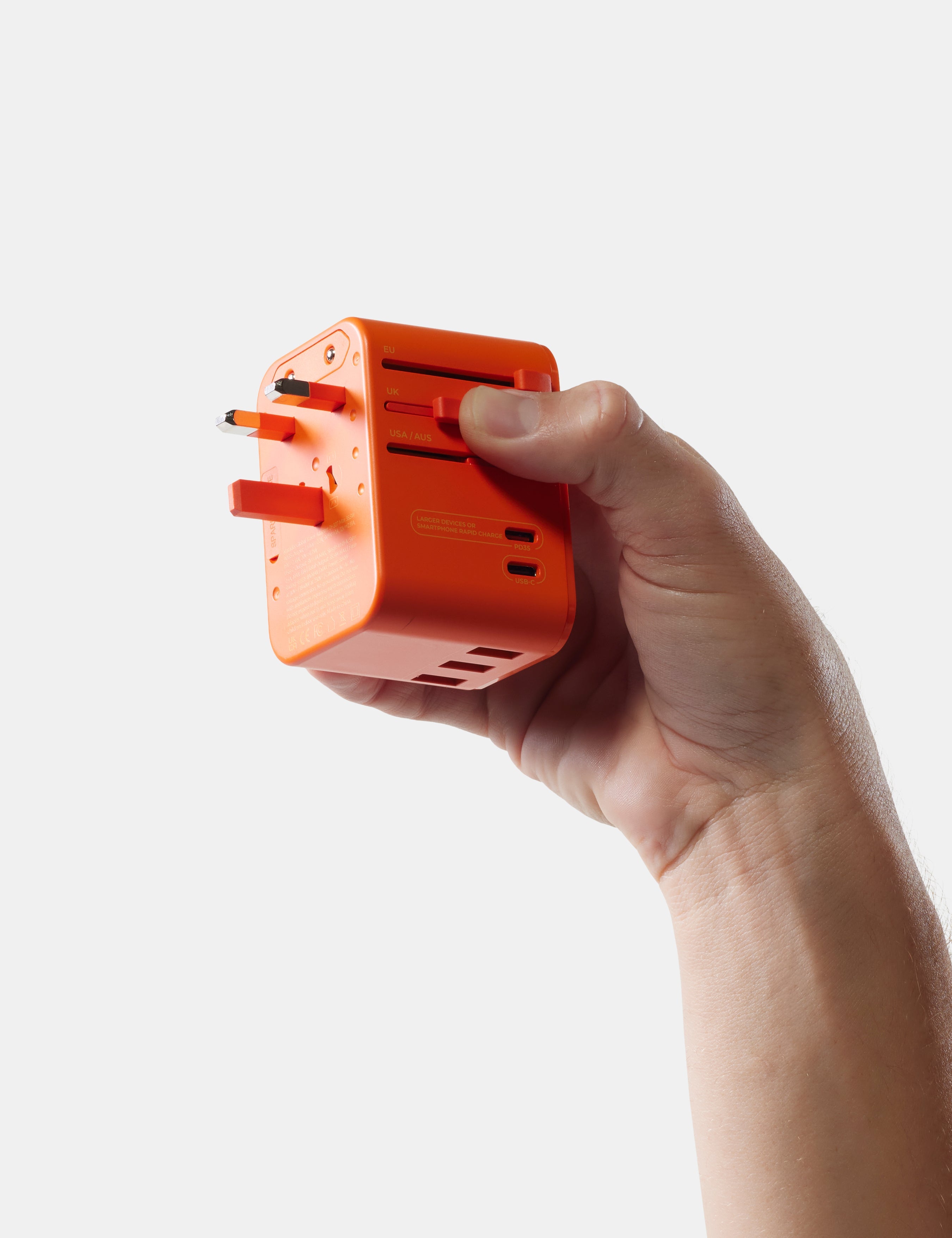 Matador Global Travel Adapter in Orange — lifestyle