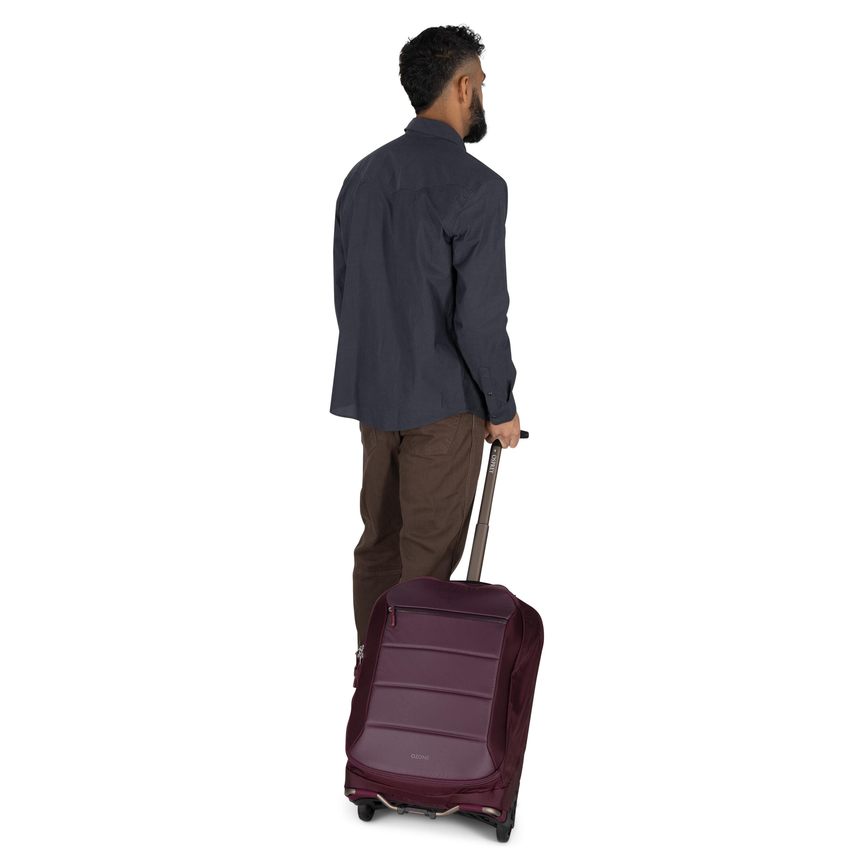 Osprey Ozone 2-Wheel Carry-On 40L/21" in Moody Burgundy — lifestyle 2