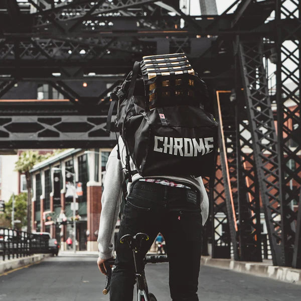 Chrome Industries Barrage Pro Pack 80L backpack – person wearing the backpack on a city street